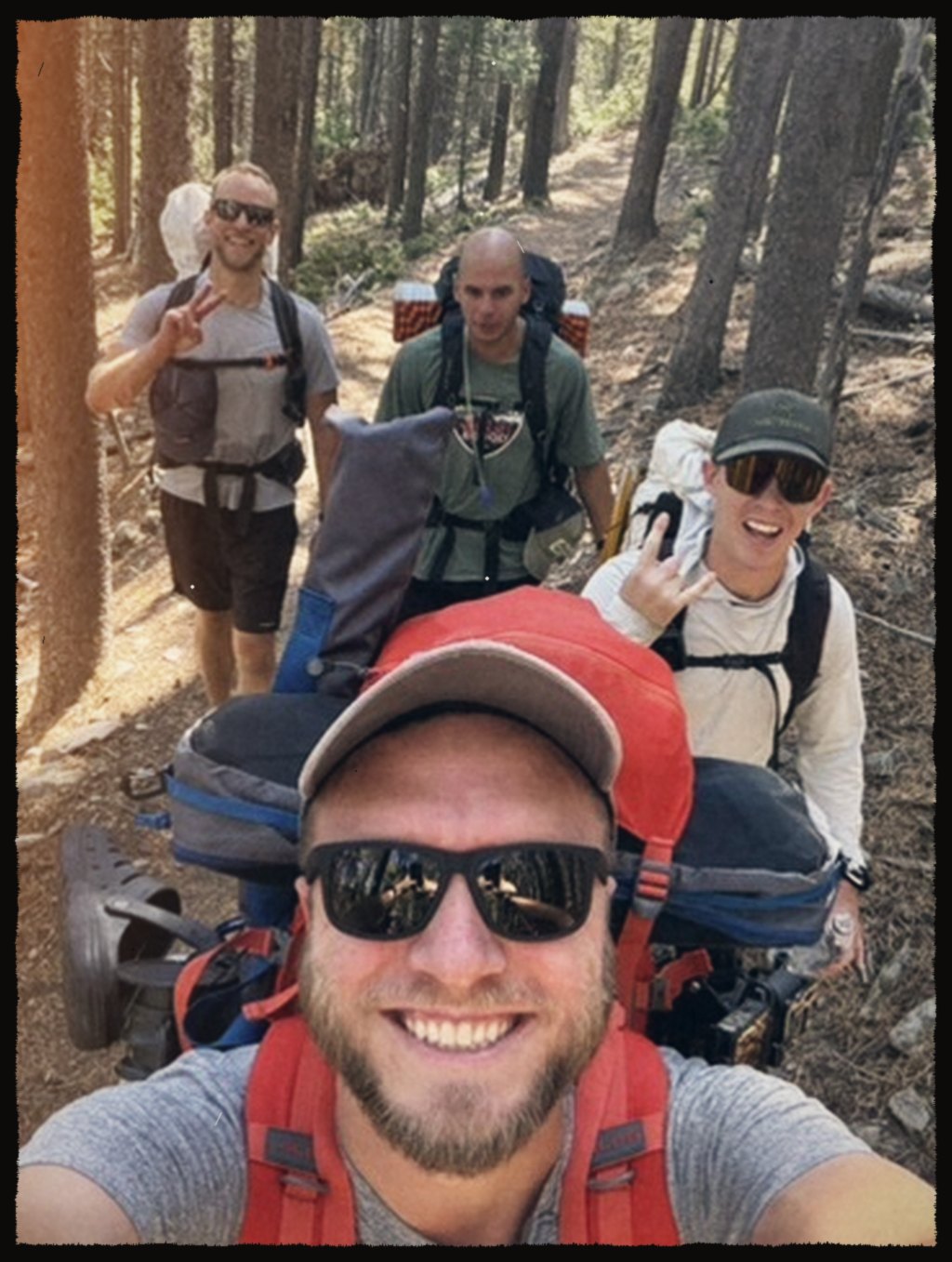 Selfie with a backpacking crew on a forest trail